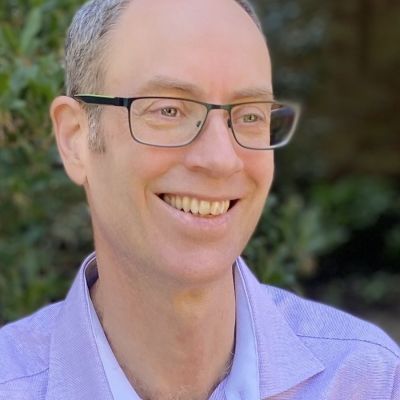 Geoff Baker: white man, wearing glasses, smiling